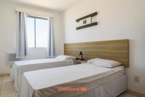 En eller flere senge i et værelse på Apartamento no Centro de Macae a Metros da Praia