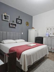 a bedroom with a large bed and a refrigerator at Pousada Santo Agostinho in Extrema +103 photos