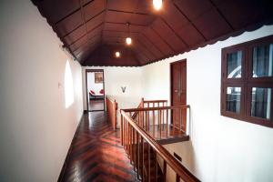 a hallway of a house with a wooden staircase at Boho Heritage in Kochi in Cochin