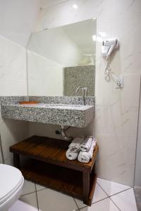 a bathroom with a sink and a toilet and towels at Tekoha Eco Hotel in Bonito +18 photos