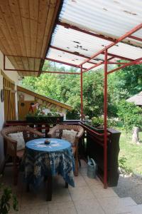 a covered patio with a table and a piano at Ferienhaus Waldhof in Döbrököz