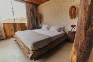 una camera da letto con un letto in una stanza con una finestra di Villa Milos a Fernando de Noronha