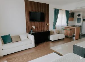 Una sala de estar con un sofá blanco y un televisor. en Luz de Laguna, en Playa Blanca