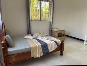 a bedroom with a bed and a stained glass window at Kijani House in Banda Kuu
