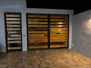 a room with two wooden doors in a room at Alojamiento en Ayangue in Santa Elena +3 photos