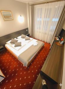 Pensiunea Sebastian في بايلي فيليكس: غرفة نوم بسرير كبير ونافذة