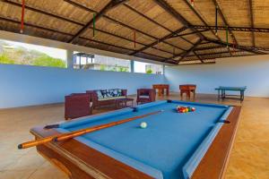 a pool table in the middle of a room at Arena Blanca Eco Hotel in Puerto Baquerizo Moreno