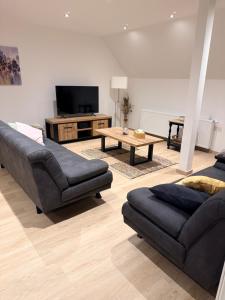 a living room with a couch and a coffee table at Carpe Diem in Ath