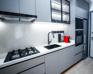 a small kitchen with a sink and a stove at Résidence LOBOS in Dakar