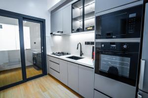 a kitchen with a sink and a stove top oven at Résidence LOBOS in Dakar +126 photos