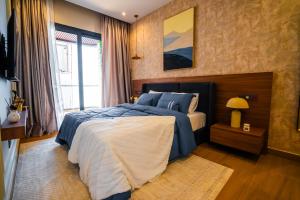 a bedroom with a large bed with blue pillows at Résidence LOBOS in Dakar
