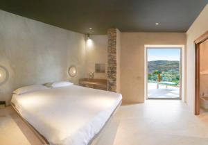 a bedroom with a large white bed and a bathroom at Le Stele Hotel in Lerici