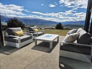 three couches and a coffee table on a patio at Bendigo Ridge - Where Activity is Relaxing in Cromwell