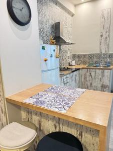 a kitchen with a blue refrigerator and a clock on the wall at Seaside Escape in Athens