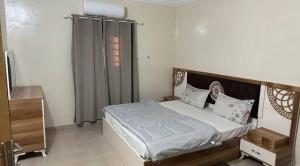 a bedroom with a bed in a room at Rose du Désert in Atar