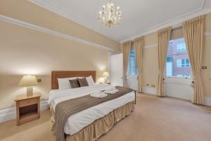 En eller flere senge i et værelse på The Mayfair Residence