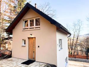 a small house with a door on a street at Domek przy czerwonym szlaku - The Red Trail Cabin in Węgierska Górka