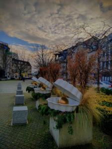 a row of toilet bowls sitting on the grass at Komfortowa kawalerka w dobrym miejscu in Świnoujście