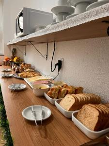 a long table with bread and other foods on it at HOTEL POUSADA POR DO SOL in Pato Branco