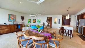 a kitchen and dining room with a table and chairs at Dream Villa in Majahua in La Majahua