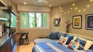 a living room with a blue couch and a window at Dream Villa in Majahua in La Majahua