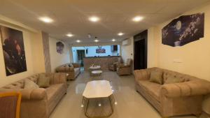 a large living room with couches and a table at Petra Desert Hotel in Wadi Musa