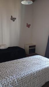 een slaapkamer met een bed en vlinders aan de muur bij Complejo Picota III in Mar de Ajó