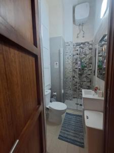 a bathroom with a toilet and a sink and a shower at 63, Casa Falzon in Rabat