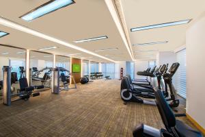 a gym with treadmills and cardio equipment in a building at Oakwood Hotel & Residence Suzhou in Suzhou