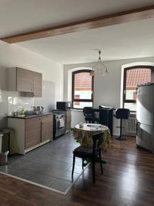 a kitchen with a table and chairs in a room at Gasthaus Higer in Wörth am Rhein