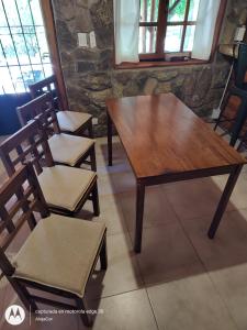 een houten tafel en 2 stoelen in een kamer bij Vado Biguá in Valle Hermoso