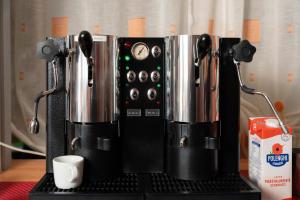 a coffee maker sitting on top of a table at La Casa Del Grillo 1 in Aosta