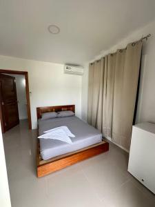 a bedroom with a bed in a white room at Villa Rio Grande in Santa Catalina