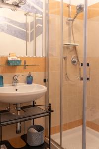a bathroom with a sink and a shower at La Casa Del Grillo 1 in Aosta +91 photos