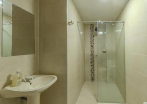 a bathroom with a sink and a shower at Hotel Stadio Cali in Cali +27 photos
