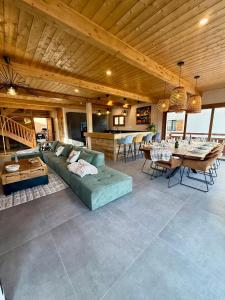 a large living room with a couch and a table at Le refuge des cimes, vue Panoramique ! in Formiguères +12 photos