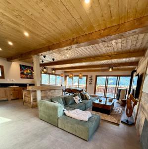 a living room with two couches and a guitar at Le refuge des cimes, vue Panoramique ! in Formiguères