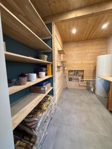 a kitchen with wooden walls and a refrigerator at Le refuge des cimes, vue Panoramique ! in Formiguères