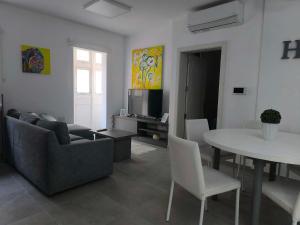 a living room with a couch and a table at Тhree bedroom house "TEA" -with garage close to the sea -SLIEMA in Sliema