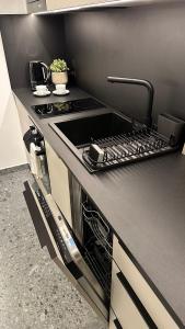 a kitchen with a stove and a stove top oven at Apartamenty MOOD HARMONY Garbary 40 in Poznań