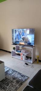 a living room with a large flat screen tv at Palm Suites Unit3 in Mbale