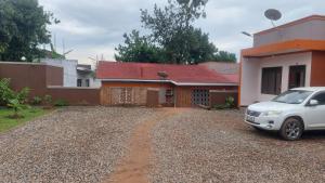 a white car parked in front of a house at Palm Suites Unit3 in Mbale