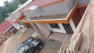 a car parked in front of a house at Palm Suites Unit3 in Mbale +4 photos