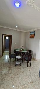 a room with a ping pong table and chairs at Purple Springs Elmina #1 in Esamang