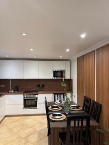 a kitchen with a table and chairs in a room at Casa Maria in Bezons