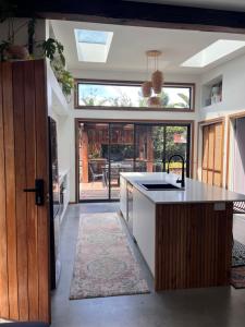 a kitchen with a sink and a counter top at Tathra Tides - Private Sauna - Walk to Beach and Cafés in Tathra