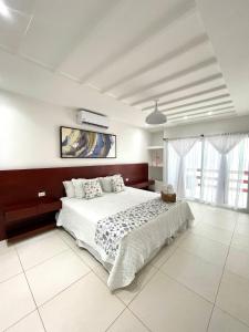 En eller flere senge i et værelse på Mariposa Reina B + 43 billeder