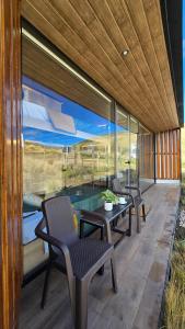 a room with two chairs and a table and a pool at Tiny house, comfort and peace facing Chimborazo in Riobamba