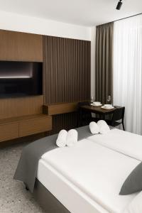 a hotel room with two beds and a table at Apartamenty MOOD HARMONY Garbary 40 in Poznań
