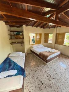 Hospedaje Doña Blanca 2 في Concepción: سريرين في غرفة ذات أسقف خشبية